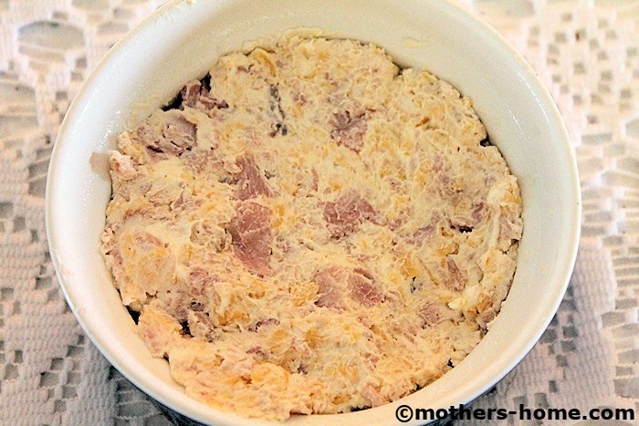 Press ham and cheese mixture into ramekin