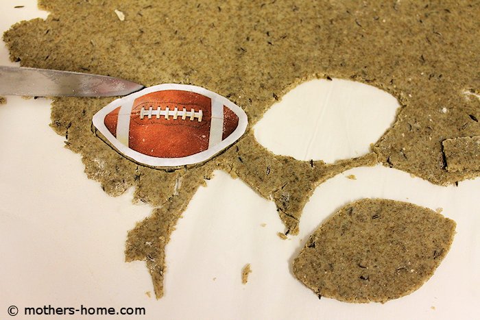 Cut a football shape in the cracker dough