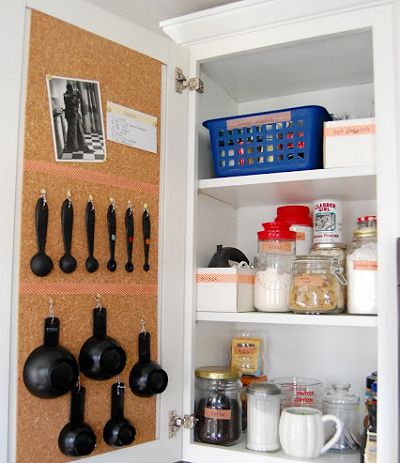 Hang corkboard on the inside of a cupboard door