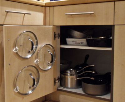 Use adhesive hooks to hold pot and pan lids