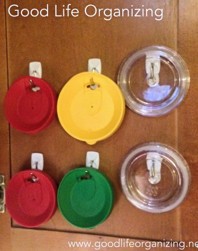 Use adhesive hooks to store lids to coffee and drink cups