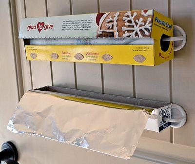 Use adhesive hooks to fold rolls of foil and plastic wrap